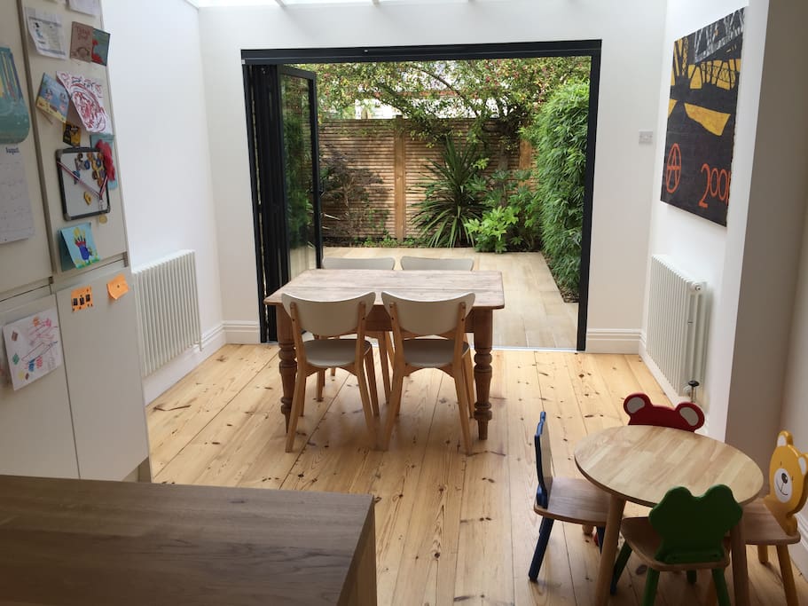 Kitchen / Dining area with bifold doors leading to patio garden