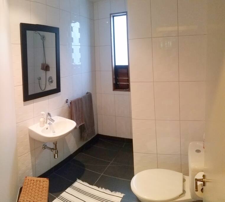 Bathroom with walk-in shower is conveniently adjacent to your bedroom.