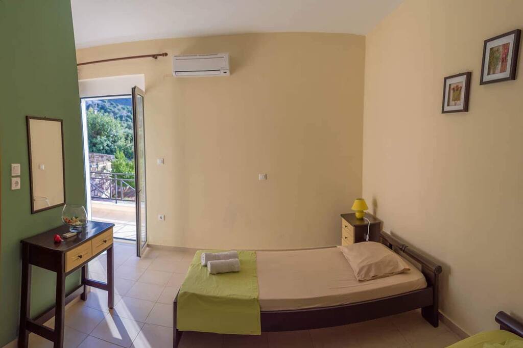 Bedroom with balcony, with view of the pool.