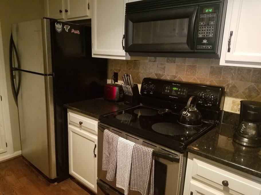 Modern kitchen with everything anyone could need, including electric griddle, coffee maker, etc.