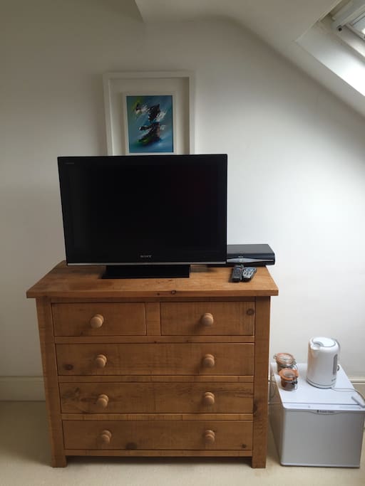 Sony flat-screen TV with Sky+ box, generous chest of drawers (containing hairdryer) for clothes storage. Tea and coffee making facilities (supplies provided) and small fridge.