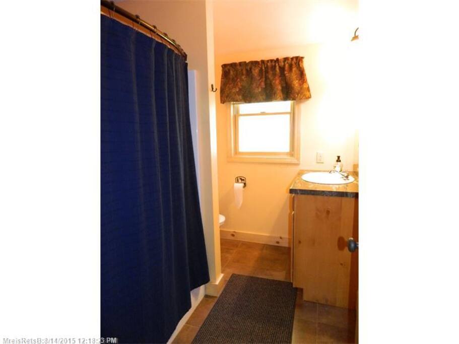 2 large bathrooms with a bathtub and one with a shower