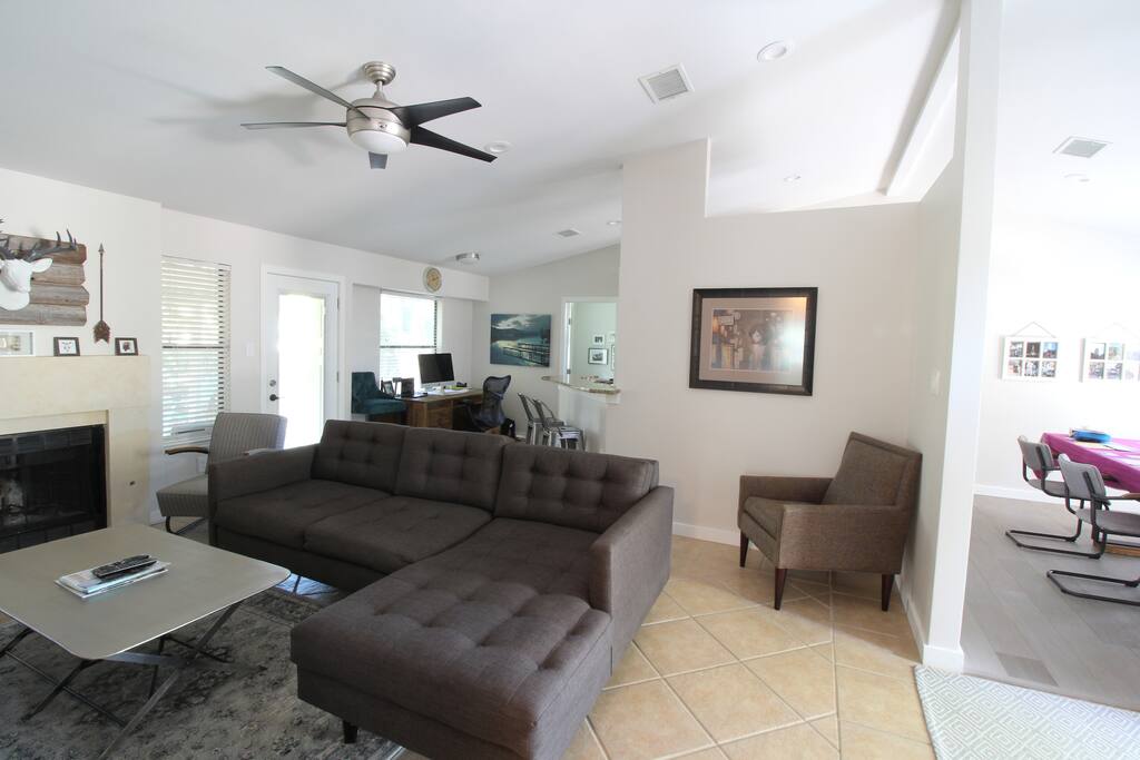 Open floor plan for the dining, living, kitchen rooms. One of the dining areas has been converted to office space with a very large desk.