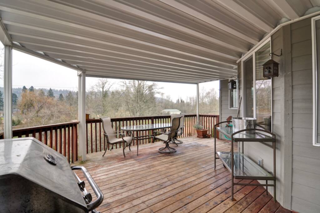 Covered deck with BBQ and seating private with view.