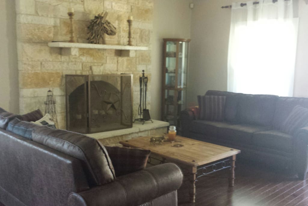 Large sitting area in front of stone fireplace