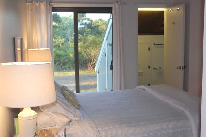 Master bedroom and bath, with sliding door out to deck.