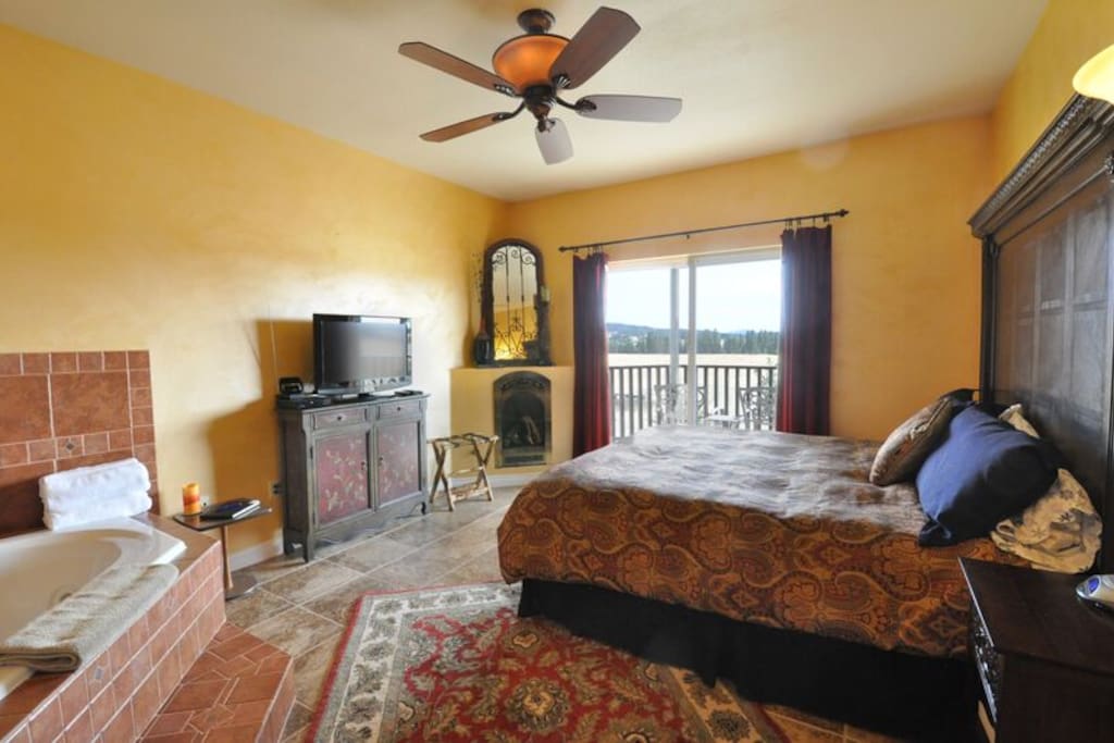 Private suite offers a dark-mahogany headboard crowing a king sized bed facing the gas fireplace. The balcony faces Mica Peak and the pine forest below.