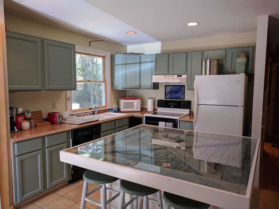 Kitchen, equipped with range/stove, microwave, dishwasher, lobster pot, and coffee maker.