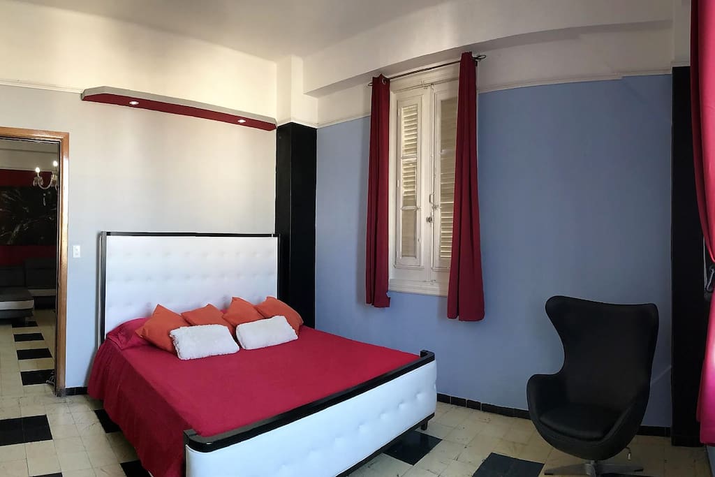 Bedroom with king size bed and comfortable mattress, from the windows an spectacular view of the city and the sea.