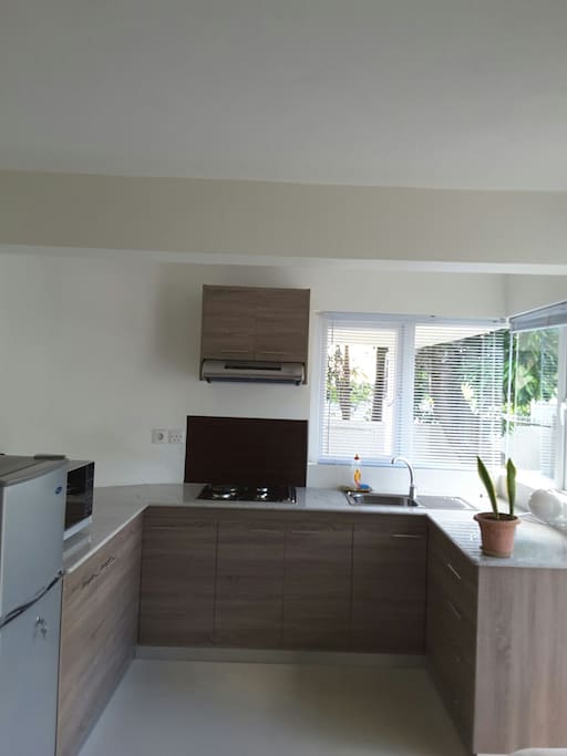 Kitchen contains all the utensils for cooking and cutlery in the storing cabinets