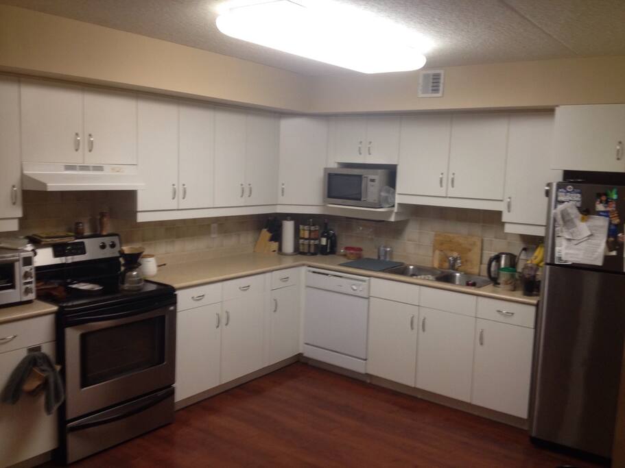 Fully stocked kitchen and fridge with condiments and spices.