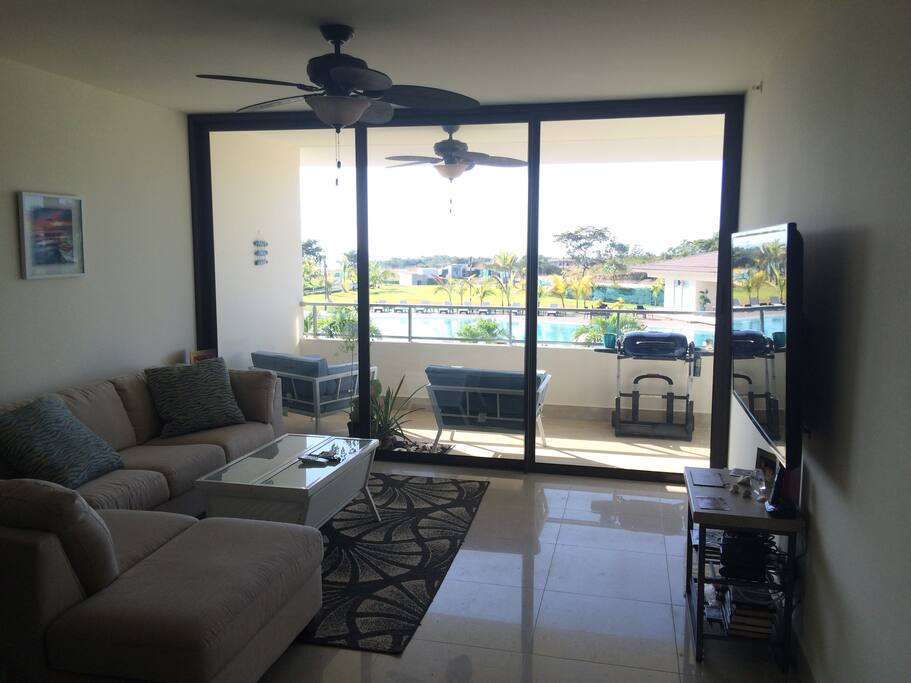 Huge living room with a wall of sliders to view the ocean and pool