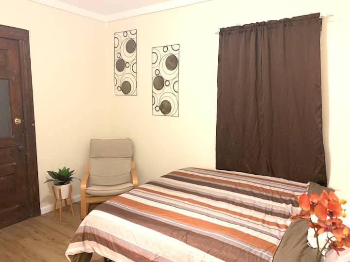 Main floor bedroom with reading chair