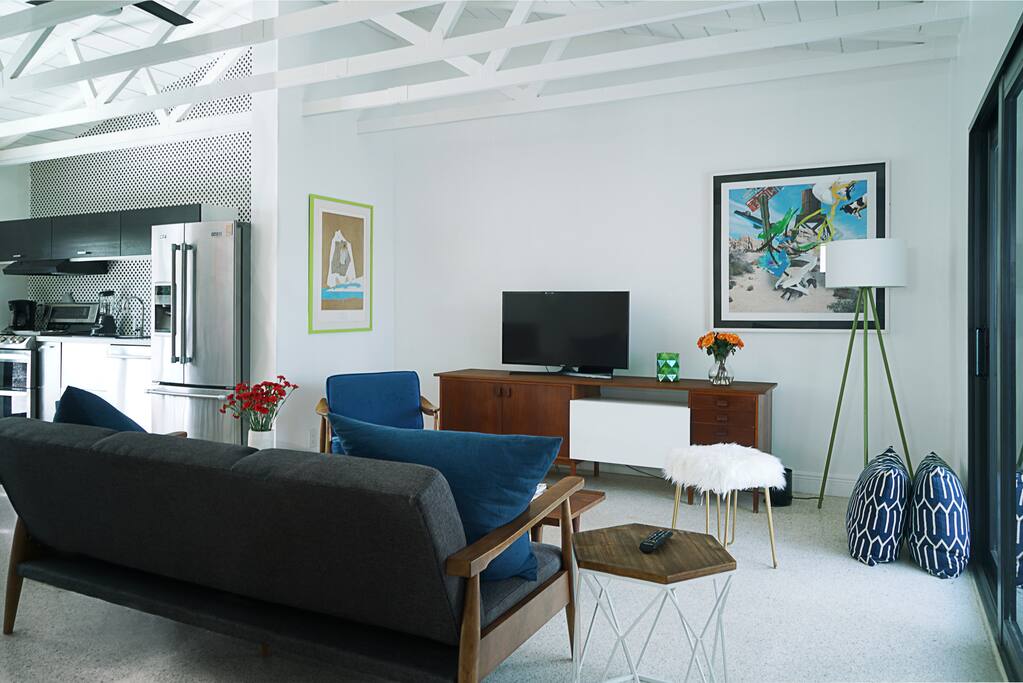 Living room furnished with great refurbished vintage Danish mid-century furnitures and Artworks from renowned pop and abstract artists.