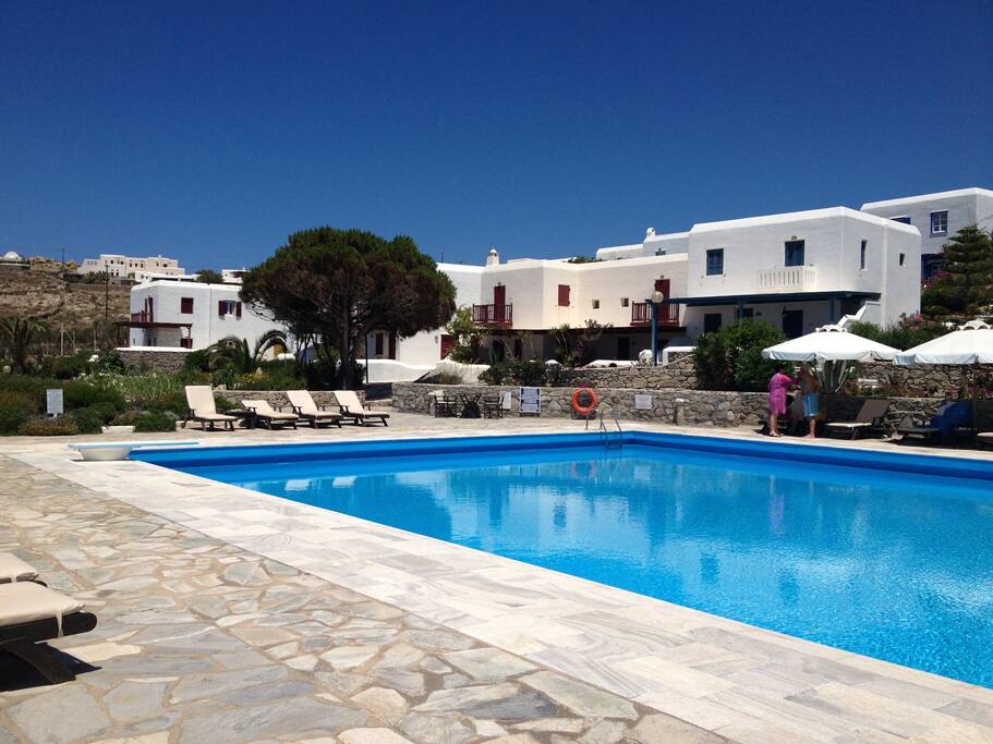 Large clean pool with bar on one side, 150 meters away from the house, within he Costa Ilios resort, where the house is situated.