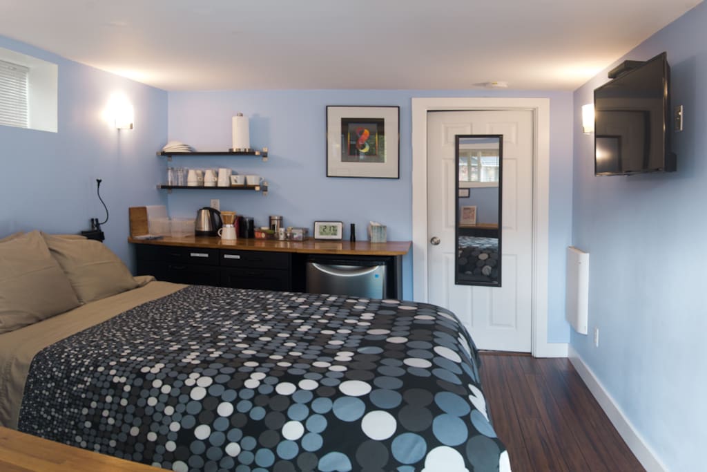 Bedroom and bathroom have all new construction. TV on wall facing bed.