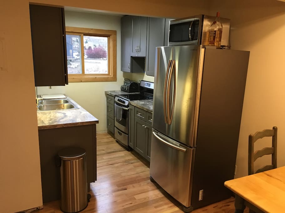 Fully remodeled kitchen with stainless appliances.