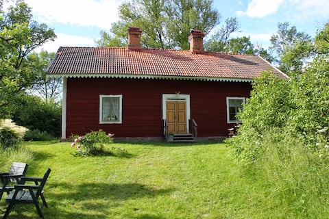 19th century cottage in oak landscape near lake and golf