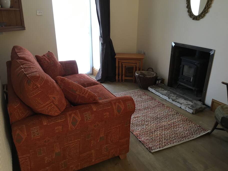 Lounge with sofa bed and log burner
