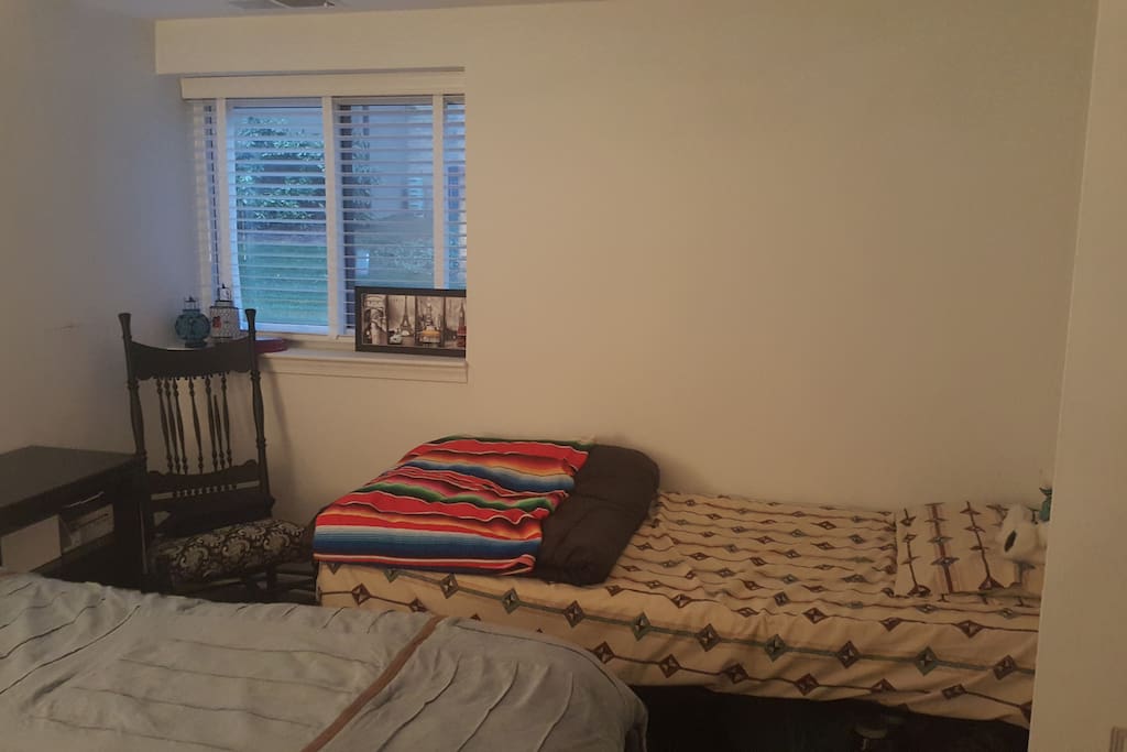 My in-laws were here for Christmas, and will be leaving next week. While they were here, we also put in a nice twin mattress for a third person in the room. Here you can see the window, which has child-safe blinds, and lots of light.