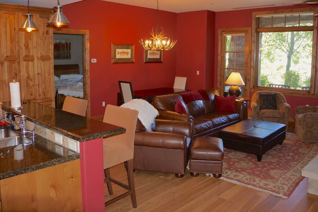 Combined living and dining area just off the kitchen. In addition to the two chairs on the ends of the table, there is bench seating on either side! Perfect for 8!