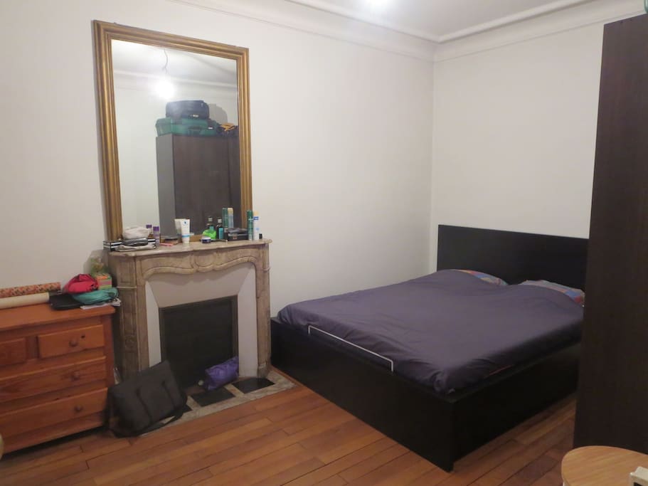 La chambre avec une grande armoire et un lit queen size