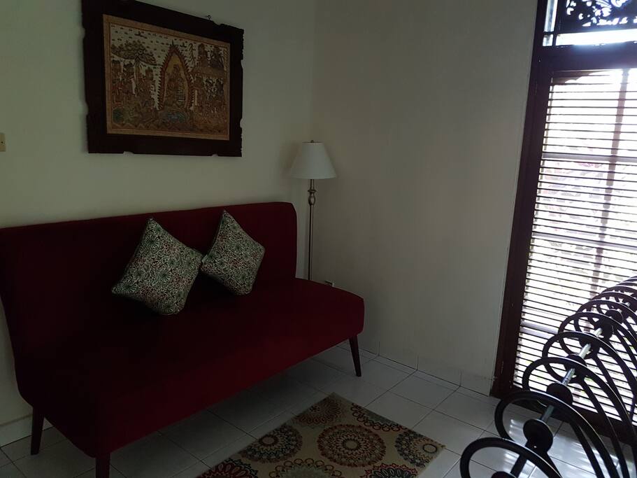 Small couch inside of the bedroom...perfect place to read a book