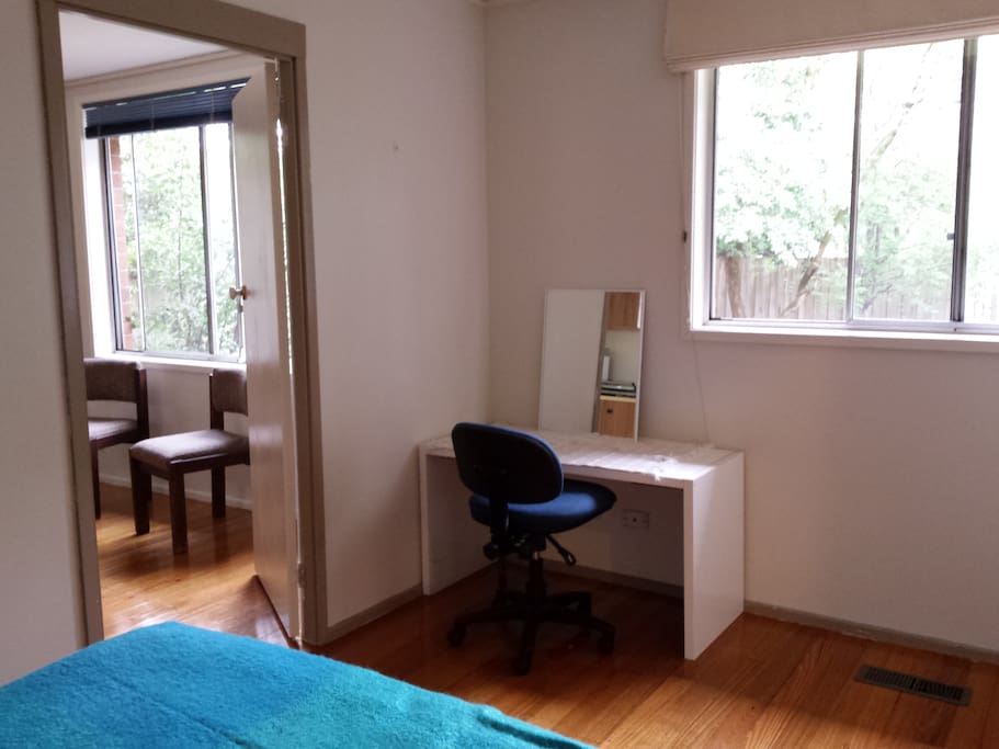 Bedroom with queen size bed, looking into sitting room