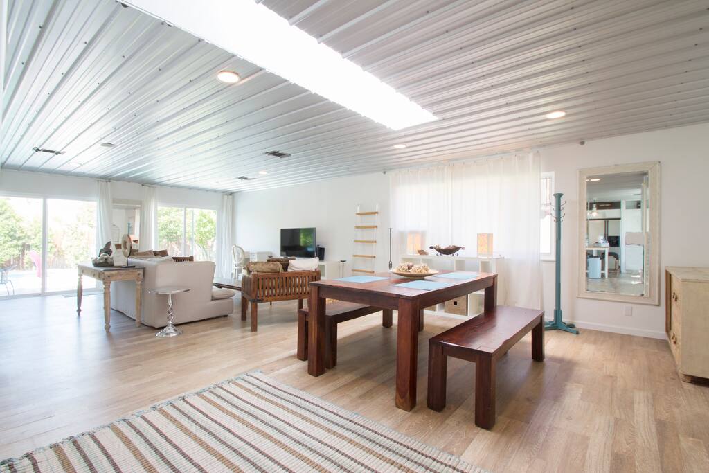 open floor plan living room and dining room and large skylight