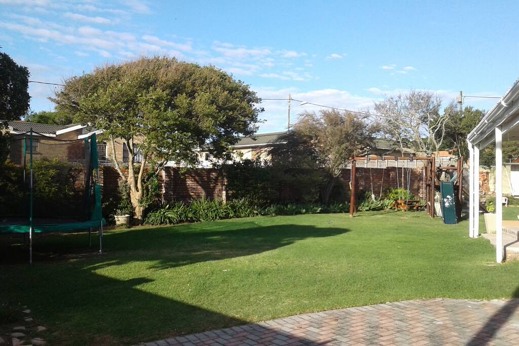 large flat front garden with 3m trampoline and a jungle gym with swings and slide