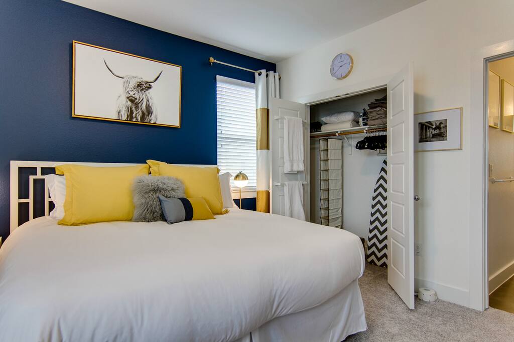 King room - large closet with hangers, ironing board & iron