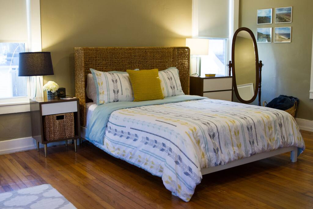 The main area of the apartment includes an open plan living room and bedroom, with lots of natural light and a high vaulted ceiling.