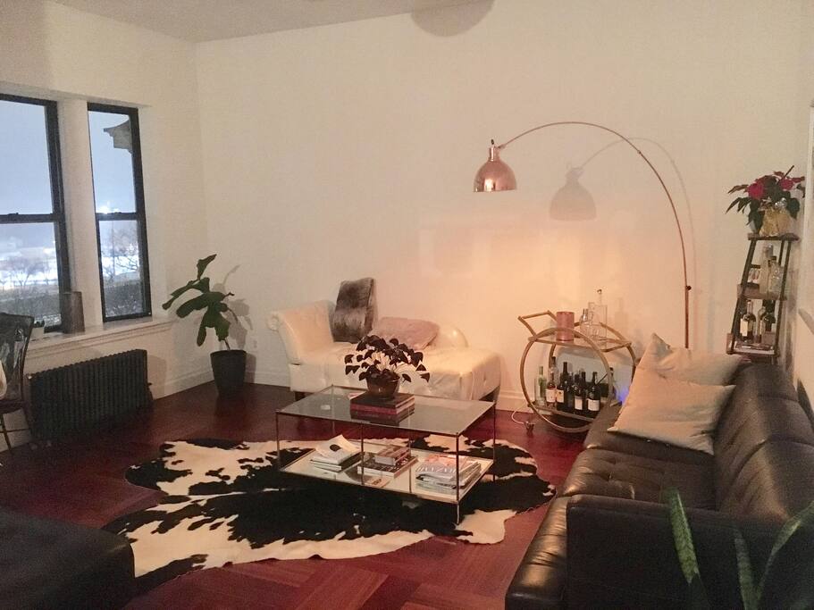 Spacious living room with sweeping views of the Hudson River and Riverside Park