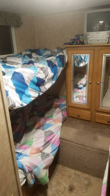 Bunkhouse style back room with two sets of bunk beds making 4 beds total.