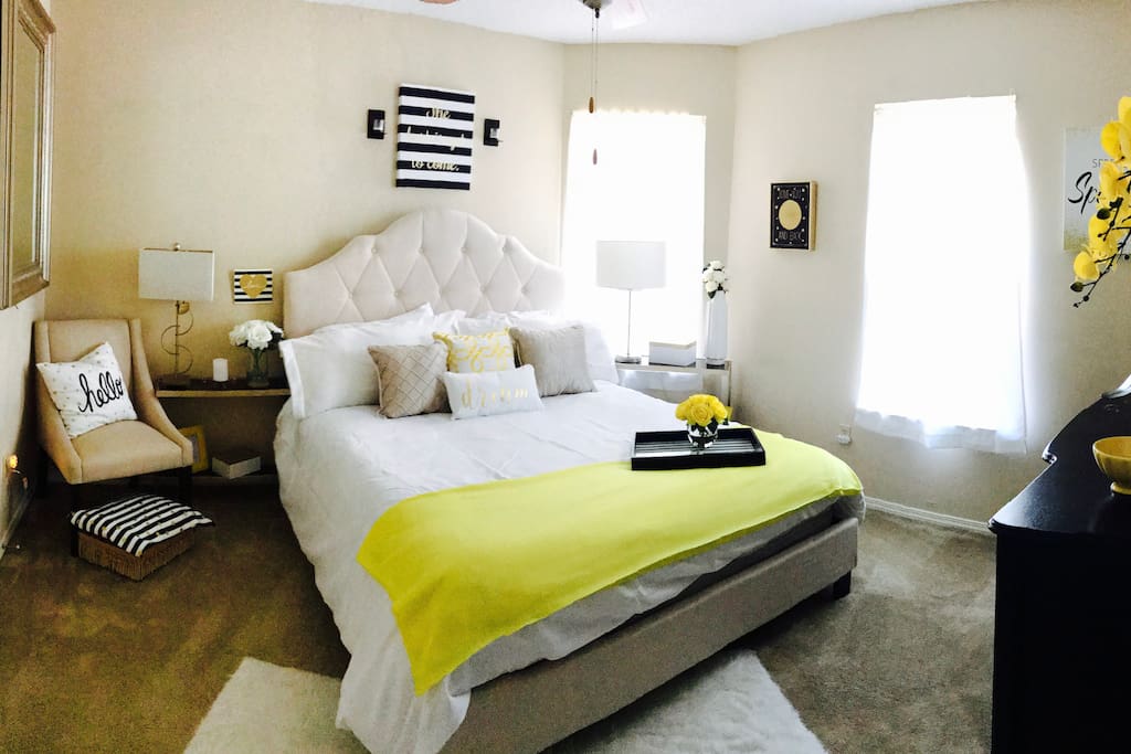 Cheerful bedroom with 800 thread count sheets adorned with down filled pillows to make your stay comfy.