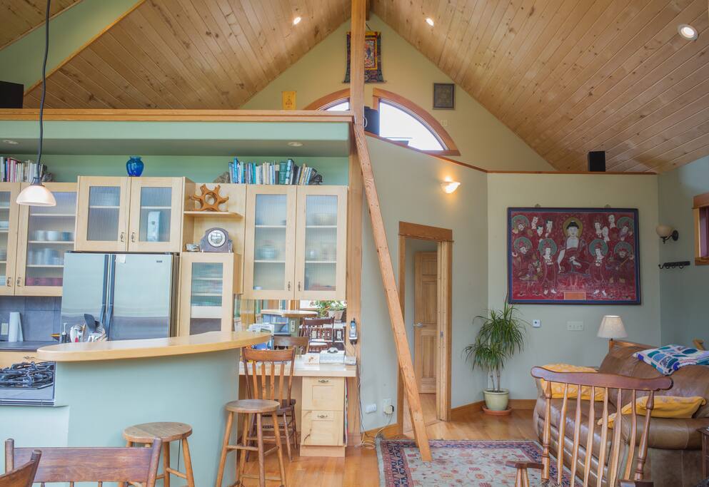 View looking at kitchen cabs and up to cabin loft. Master door on right.