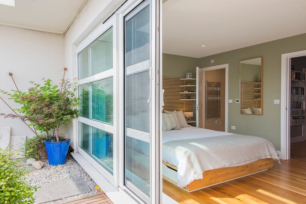 Master bedroom with ensuite bathroom and sliding doors to private terrace