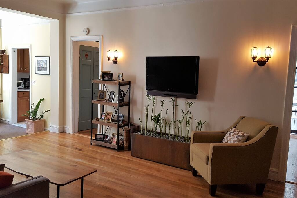 Living room and hallway entrance to bathroom.