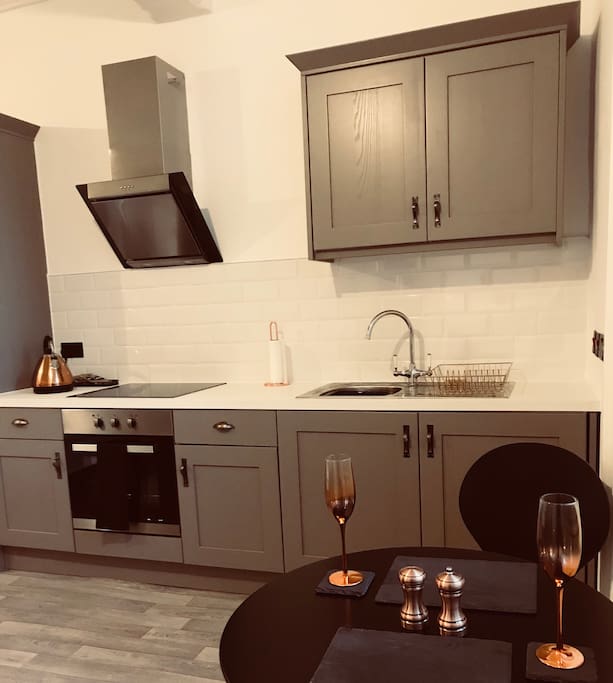 Kitchen - electric over, hob, fridge/freezer. Crockery and utensils provided .