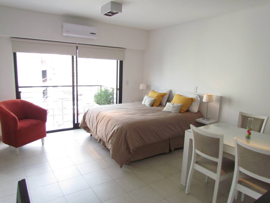 Fully equiped bedroom with comfy red sofa and queen size bed (option to separate and have two twins). Dining area.