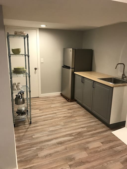 Kitchenette stocked with all new appliances, cookware, and dishes.