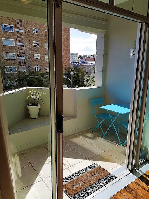 Sliding doors leading onto the balcony with table & chairs