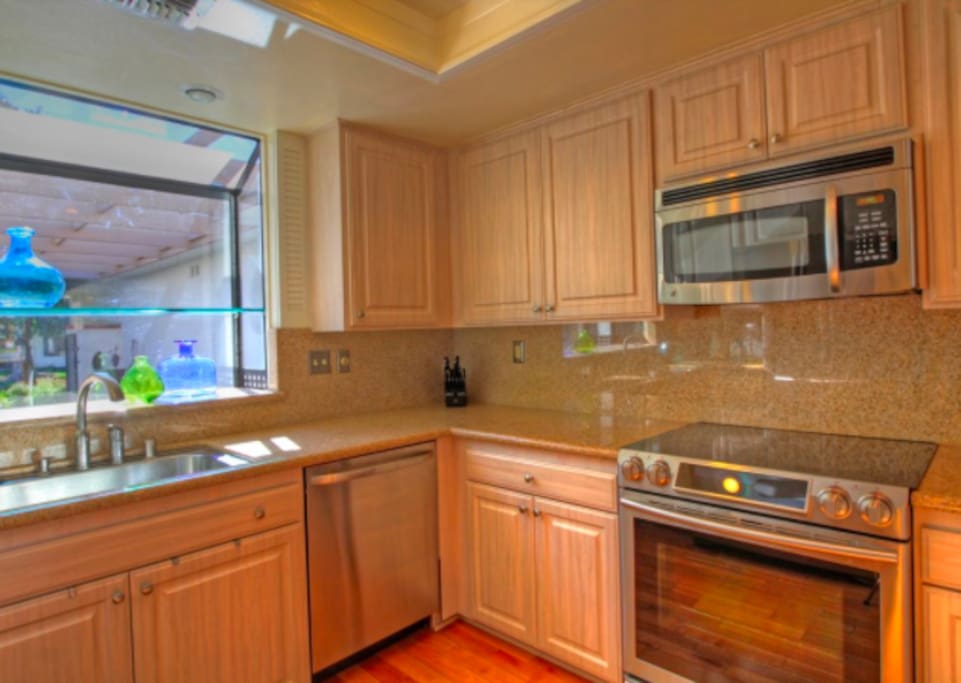 Kitchen with slab granite counters. stainless appliances