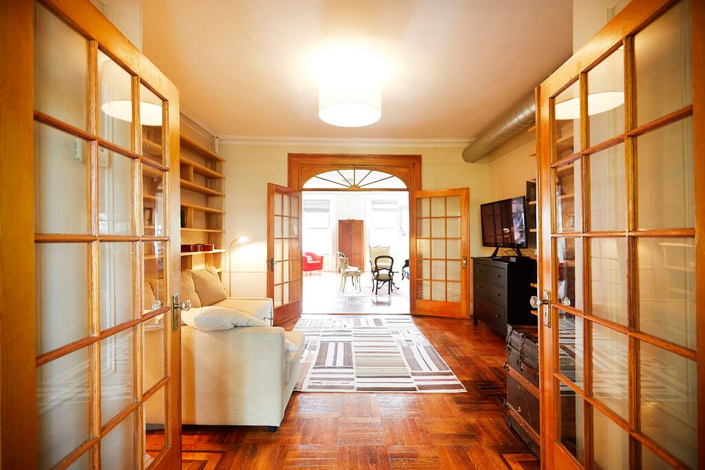 View from kitchen, though the den, to the living room with windows facing the street.