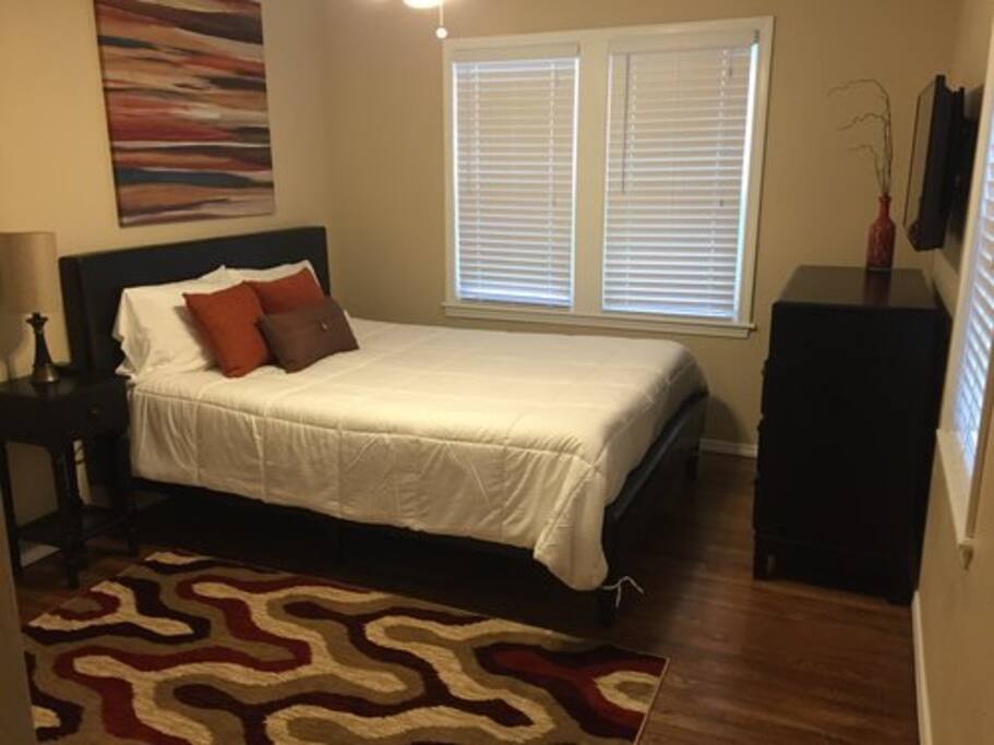 Comfortable queen with TV and plenty of storage.