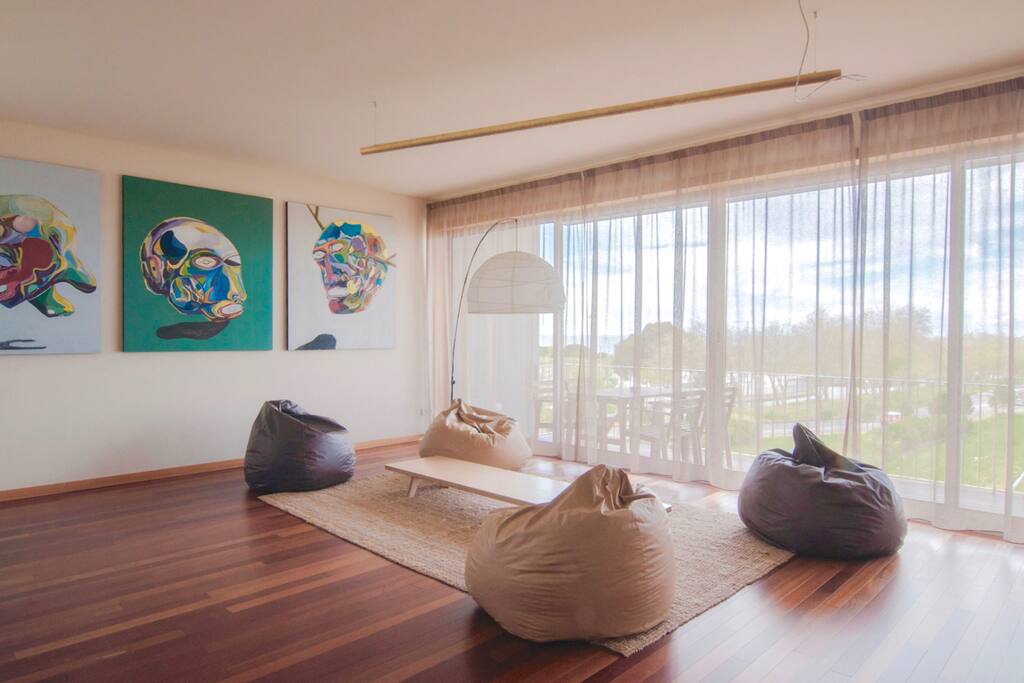 Confortable poufs close to the balcony, perfect for reading and having a drink