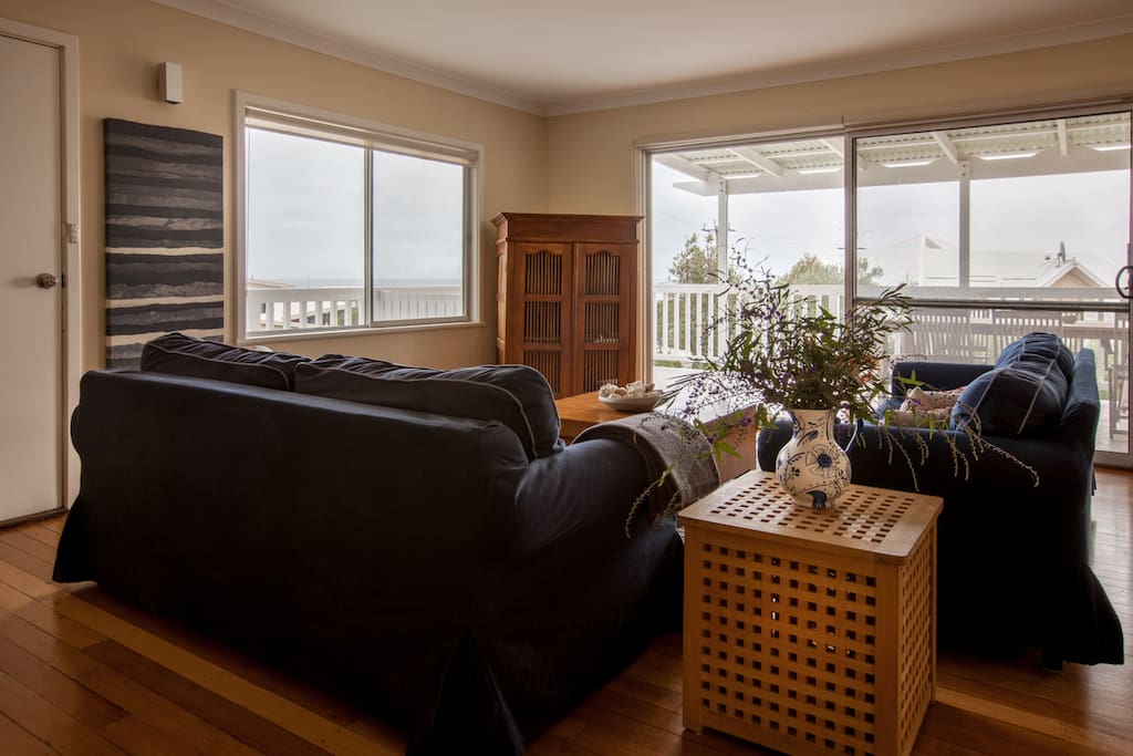 Comfortable living room, flows onto outside deck with bay views