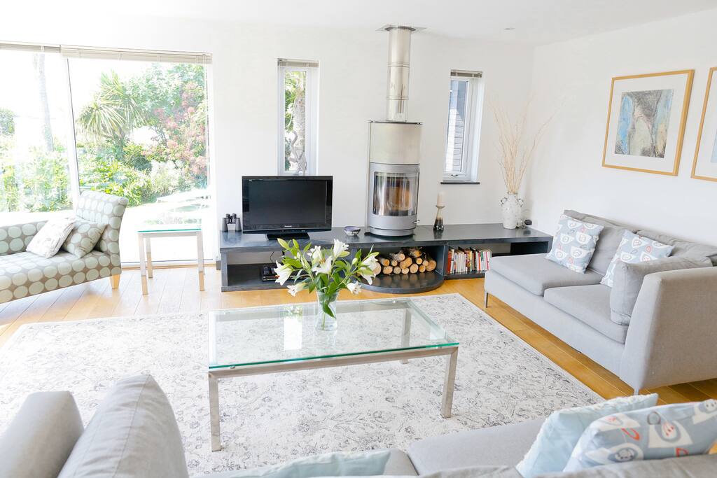 Lounging with stunning views across the flowers to the ocean, headland & horizon