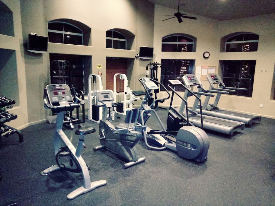 Large exercise gym with new equipment and mounted tv's. Equipment and gym are kept clean