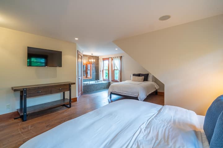 Upstairs: There is the largest of the bedrooms with a king bed, a queen bed and...